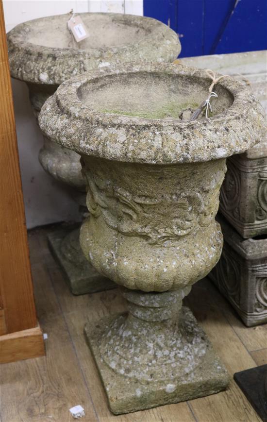 A pair of reconstituted stone campana-shaped urns, W.43cm H.66cm